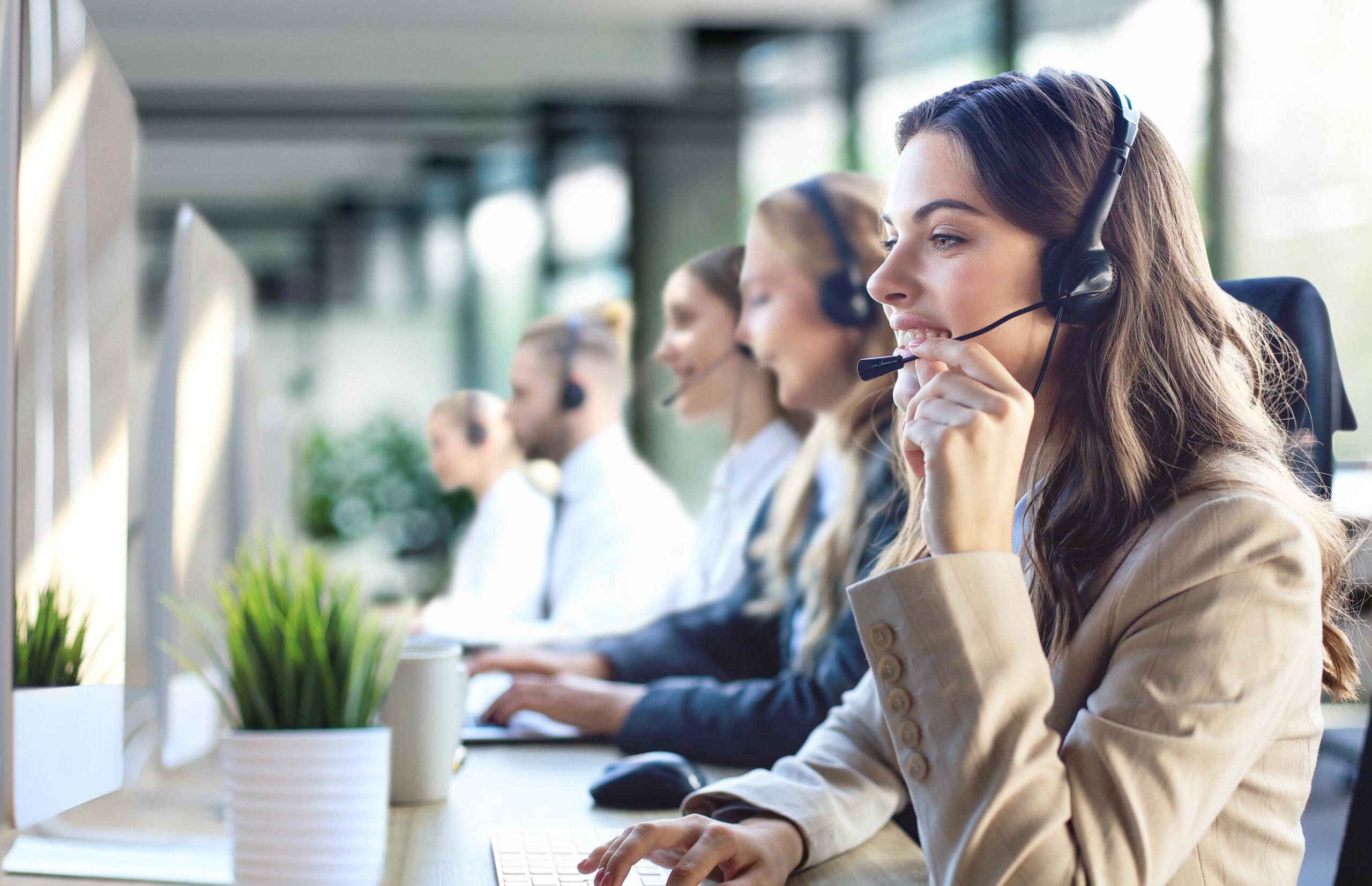 Female,Customer,Support,Operator,With,Headset,And,Smiling,,With,Collegues Female,Customer,Support,Operator,With,Headset,And,Smiling,,With,Collegues